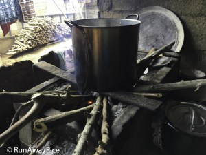 Open-fire stove and the pile of wood needed for cooking | runawayrice.com